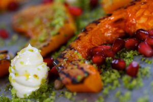 Chargrilled Butternut Squash with Goats Cheese Cream, Pomegranate and Pistachio Migas