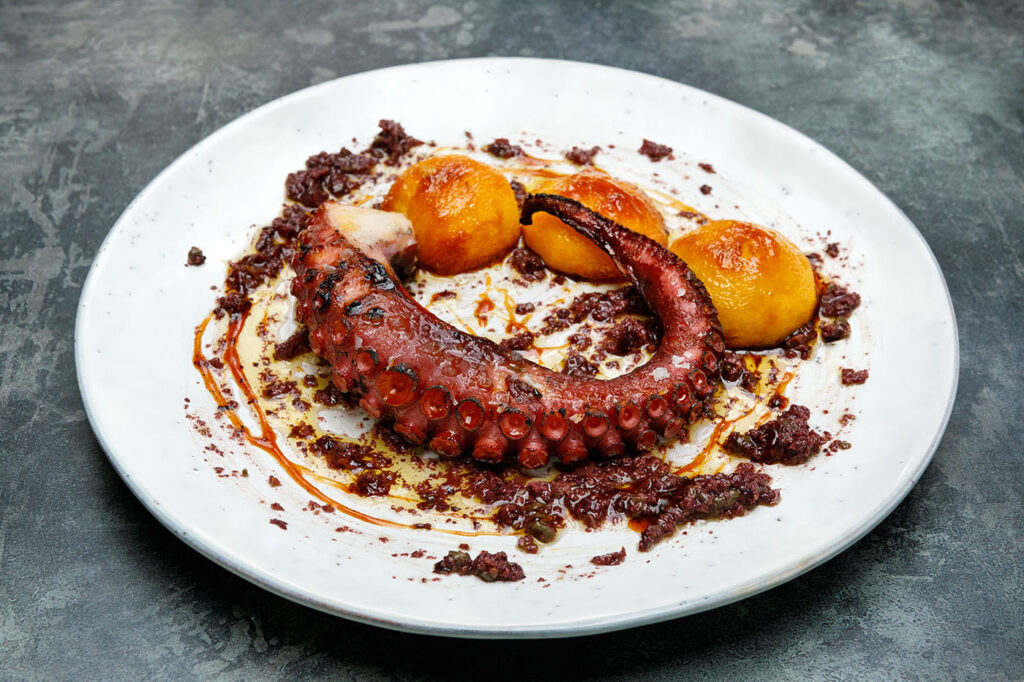 Barbecued Octopus, Caramelised Peaches and Black Olive Tapenade