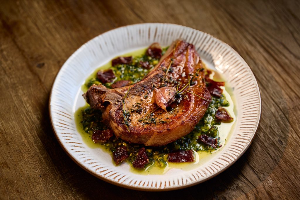 Chestnut-Fed Pork Chop with Pistachio Pesto and Crispy Jamón Ibérico